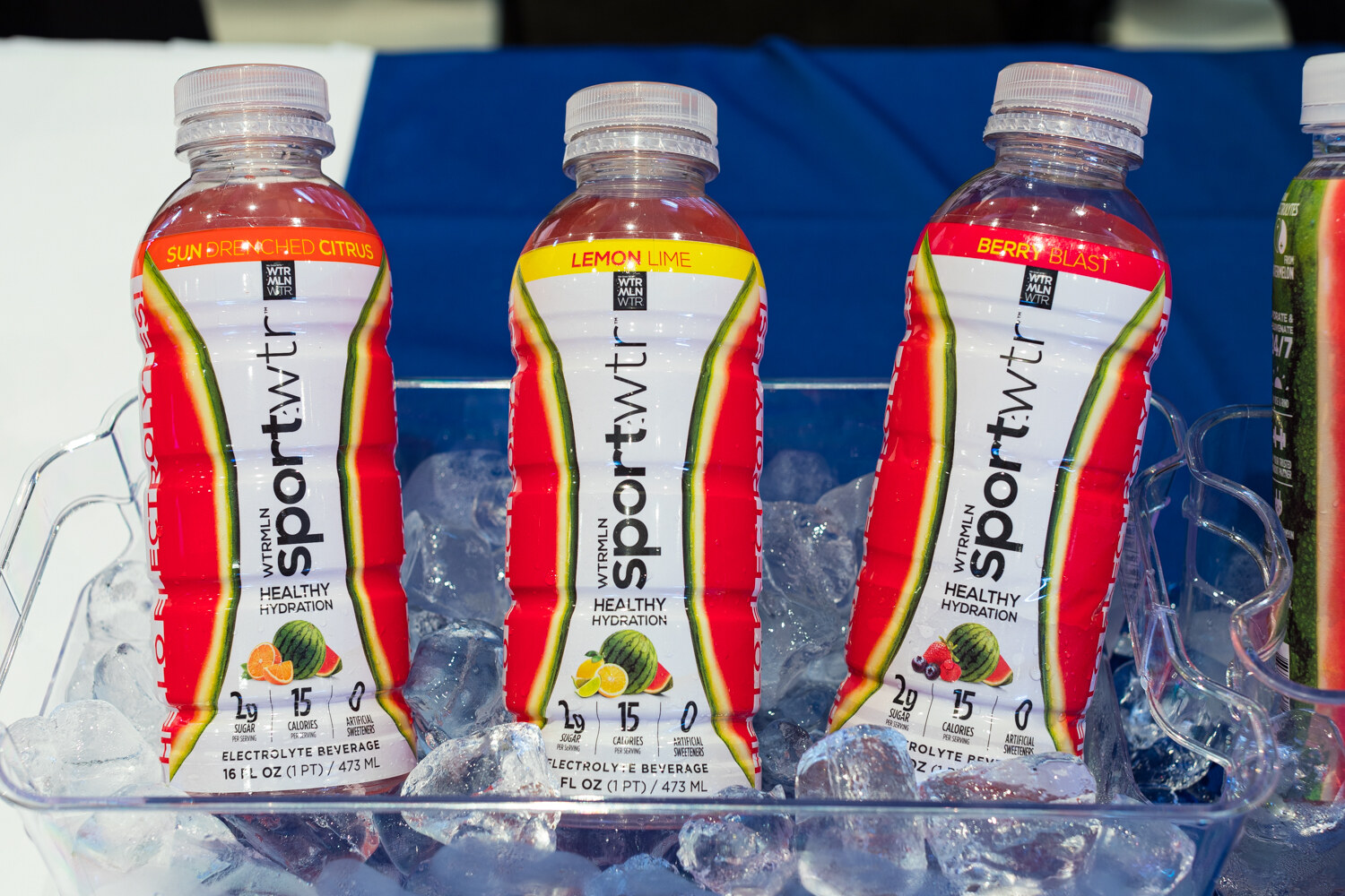 Photo of three bottles of Sportwtr electrolyte beverage sitting in ice.