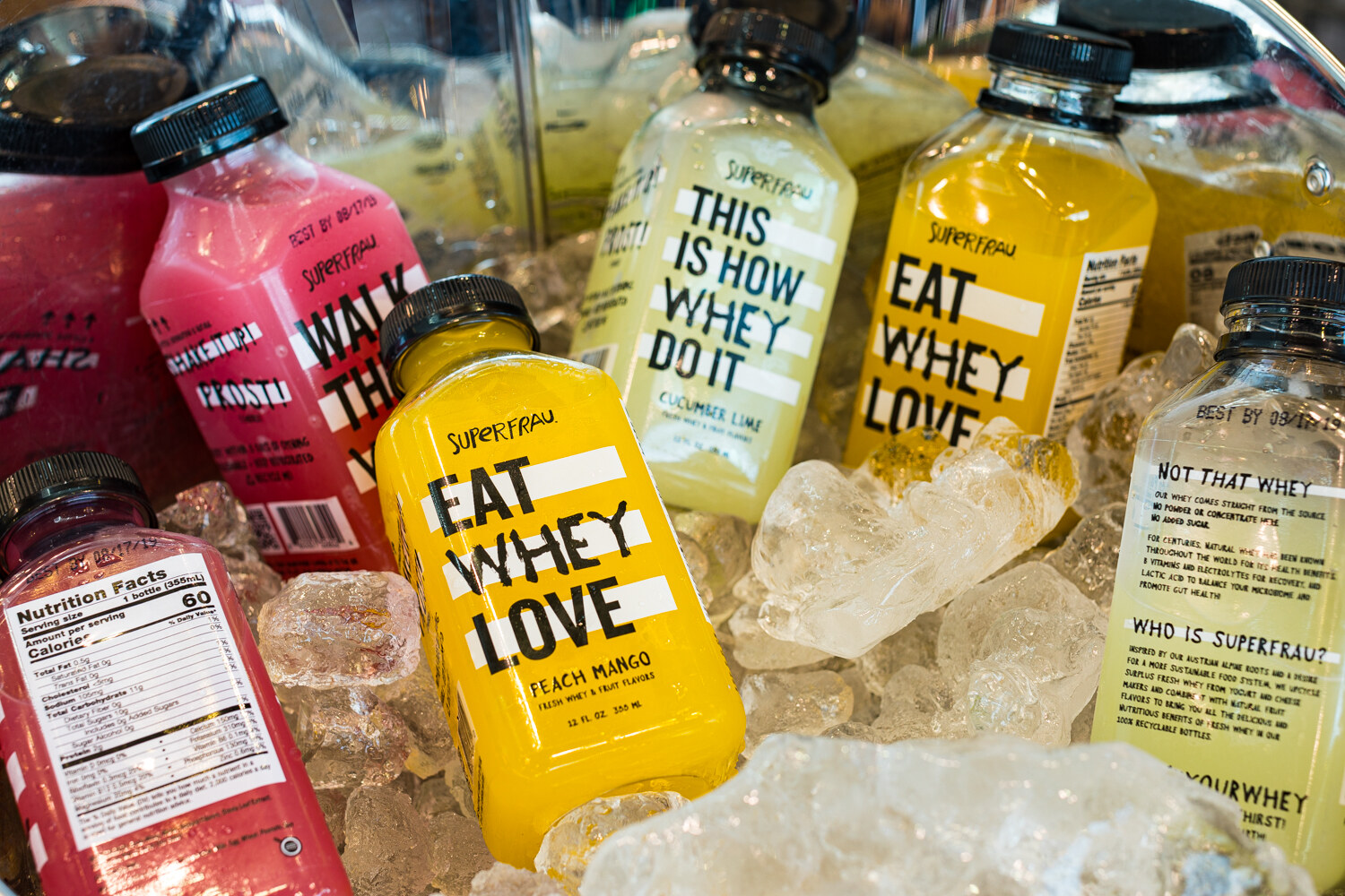 Photo of iced bottles of whey drinks with bold lettering such as Eat Whey Love.