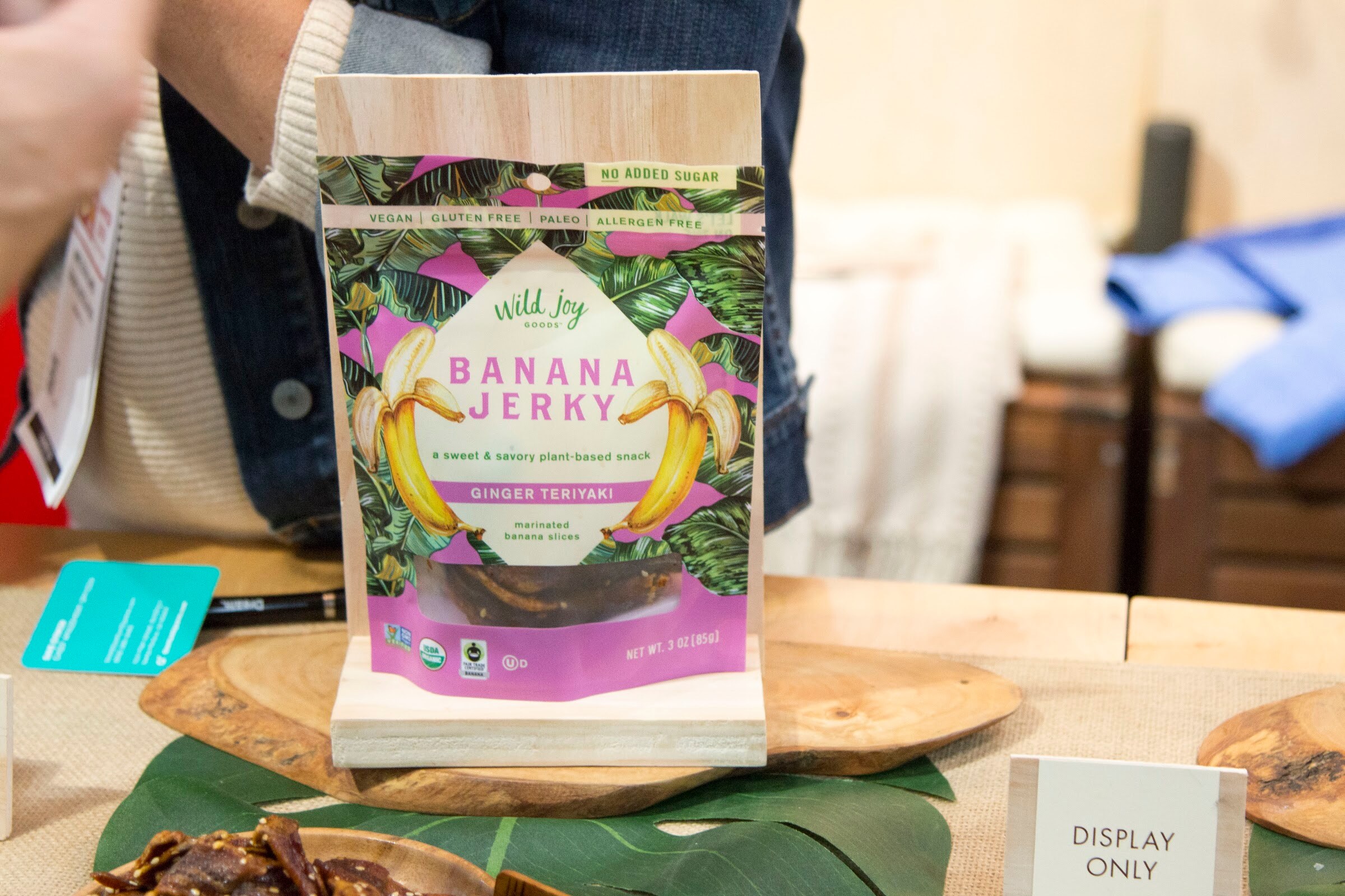 Photo of a bag of Wild Joy banana jerky held up on a display stand.