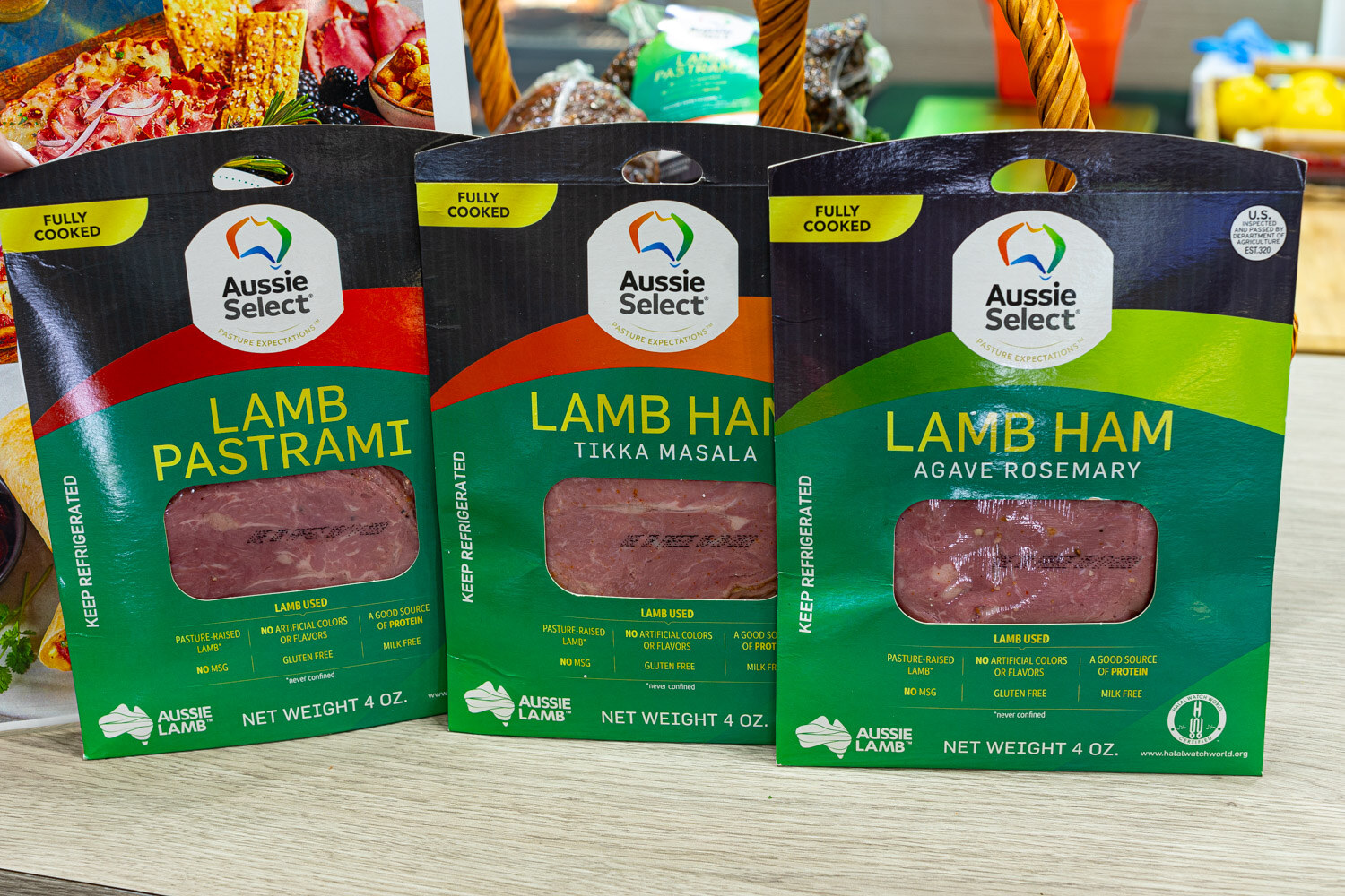 Three packs of Aussie Select fully cooked lamb pastrami and lamb ham in tikka masala and agave rosemary flavors