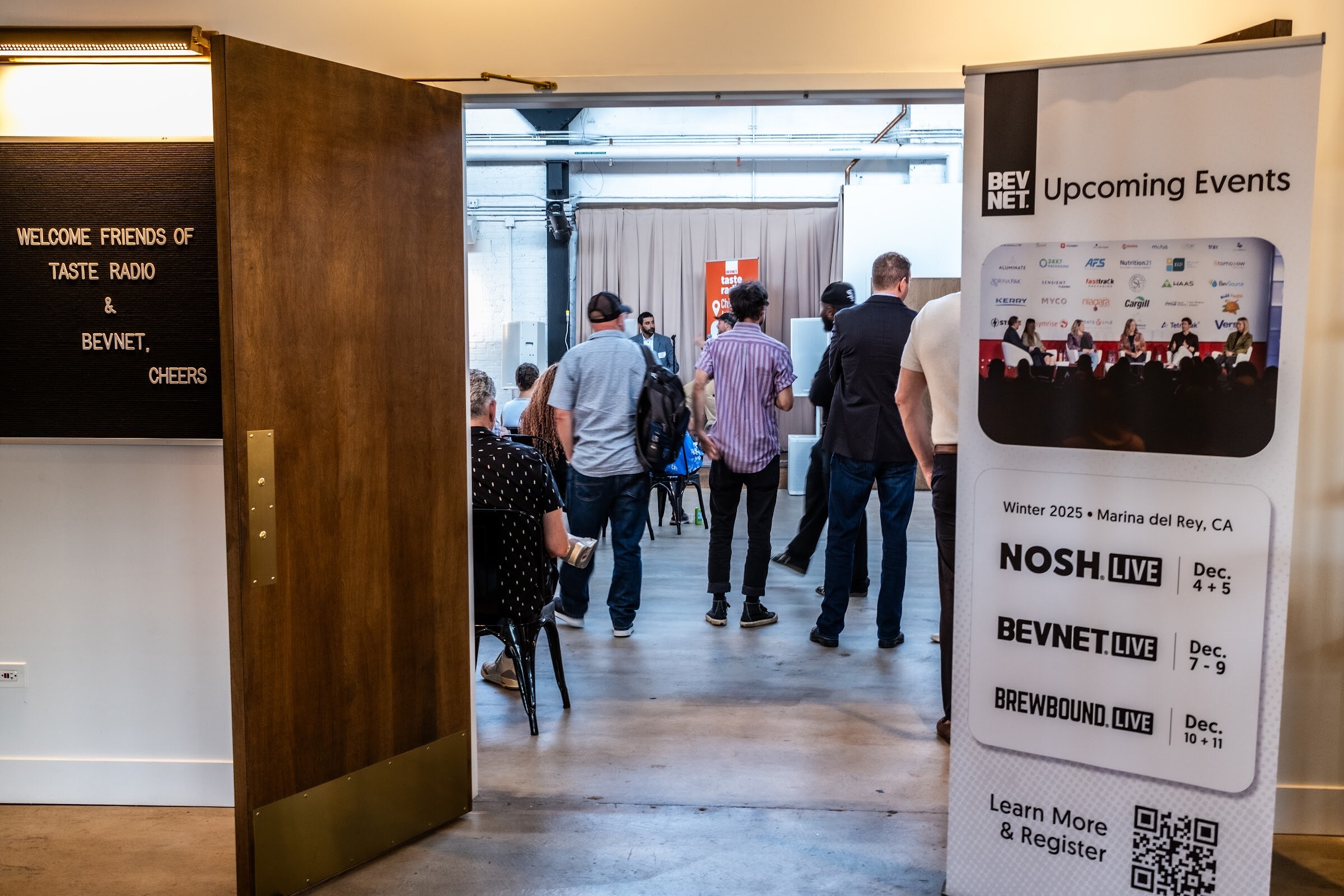 Doorway into the event room with a BevNET upcoming events banner and the welcome board visible.