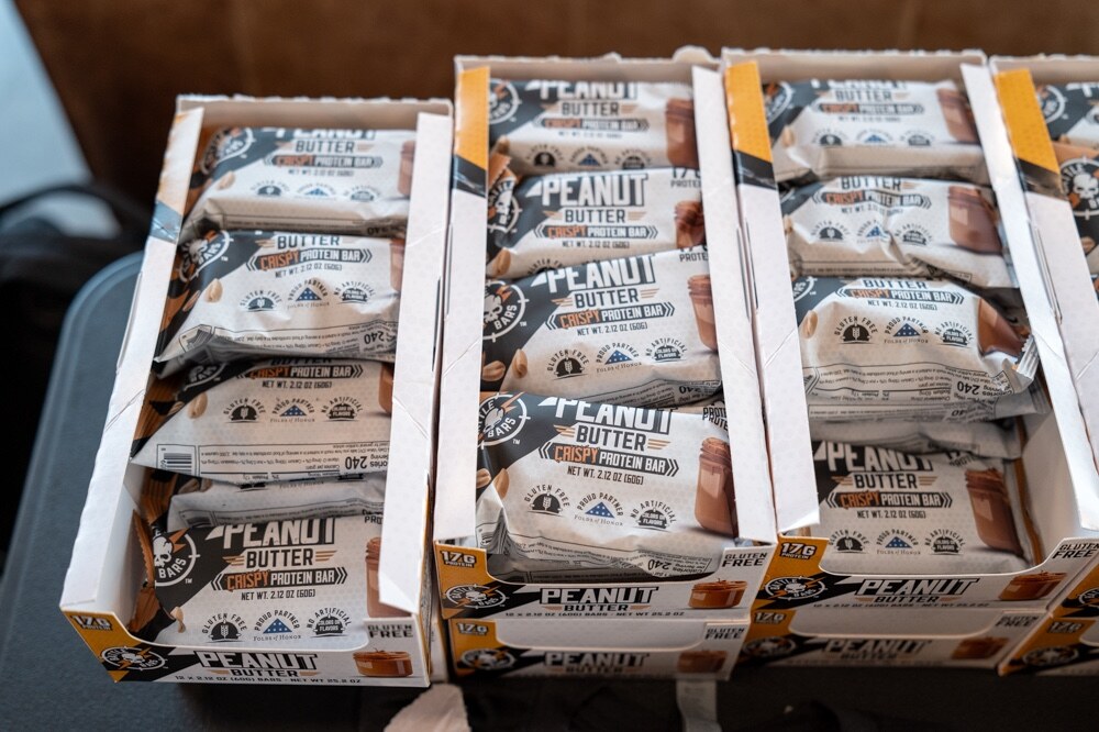 Open boxes of Battle Bars peanut butter crispy protein bars.